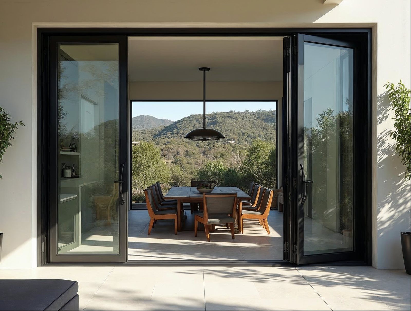 Bi-fold glass wall system 6-panel open on California hillside home compared to sliding glass wall systems